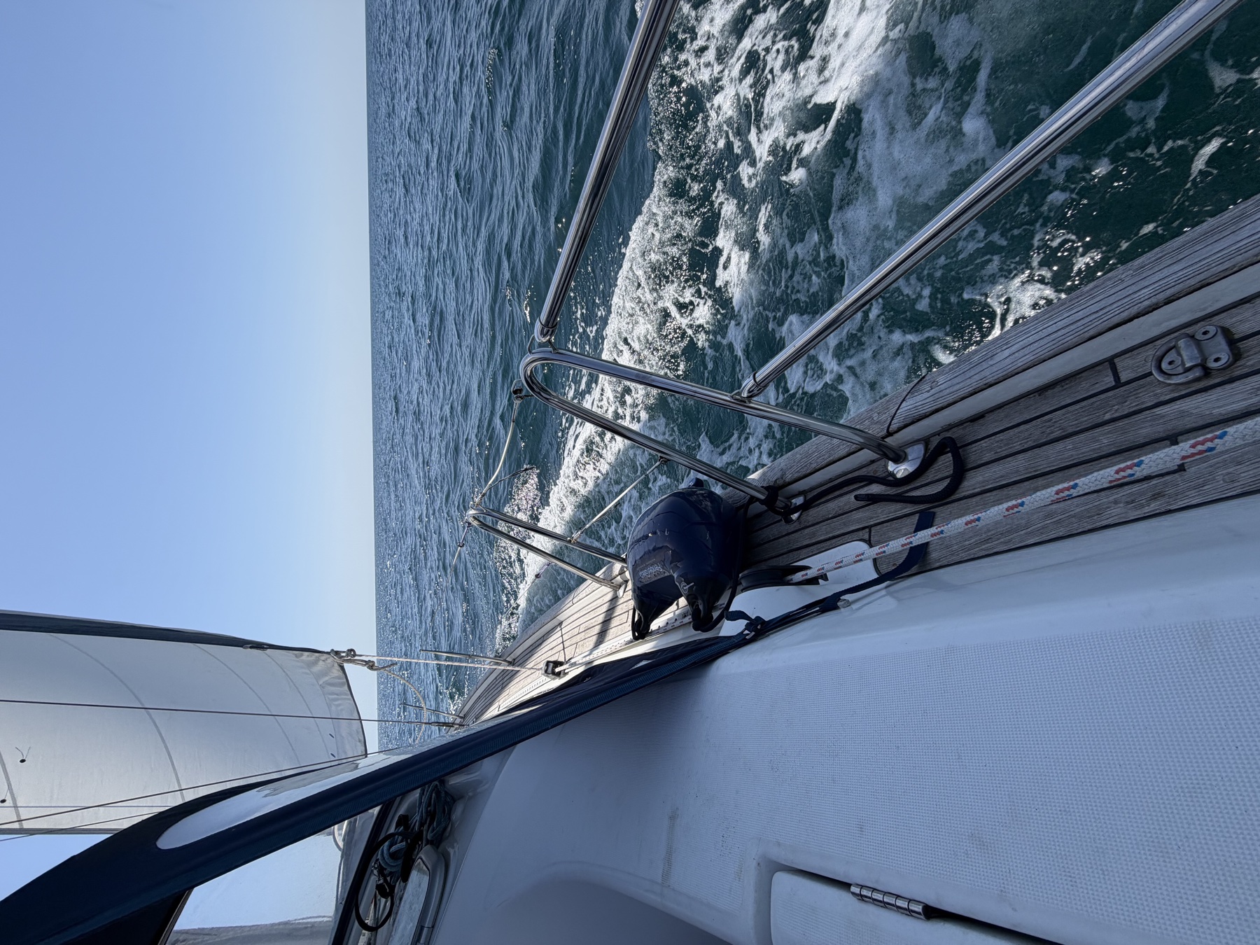 Looking forward along Phoebe Jo’s deck as she sails through sparkling blue water